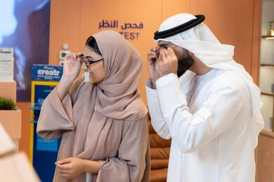 الاهتمام بالمظهر الخارجي، مواكبة آخر صيحات الموضة والجمال، زوجان عربيان خليجيان اماراتيان يقومان باختيار نظارة شمسية ملائمة لملامح الوجه، حماية العينين من أشعة الشمس، المتعة بالتسوق في مولات الإمارات