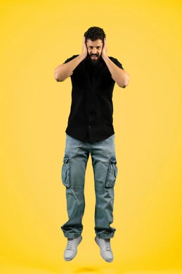 Remembering something, receiving unexpected happy news, a young Emirati man looking at the camera with gestures of shock, wonder and amazement, being surprised by a specific situation, feeling astonished and amazed, portrait of a Saudi Arabian Gulf man wearing casual summer clothes and putting his hands on his face, full body photo, yellow background