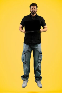Using modern devices to accomplish tasks, portrait of an Arab Gulf Emirati man wearing casual clothes holding a laptop, a Saudi young man displaying a blank black screen via laptop, full body, yellow background