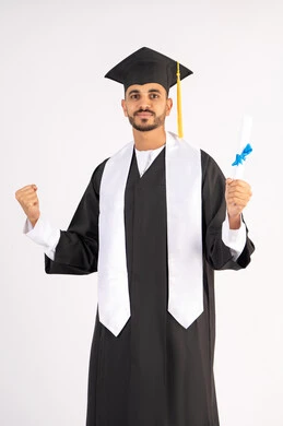 Pride in achieving dreams and success, raising a fist with an expression of achievement, looking at the camera with gestures of happiness and joy, celebrating the completion of the university stage, a portrait of an Arab Gulf Emirati graduate wearing a graduation cap and gown, holding a certificate in his hand, white background