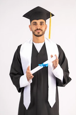 Celebrating the completion of university, expressions of joy and happiness for success, taking selfies in graduation clothes, portrait of a smiling young Arab Gulf Emirati graduate wearing a graduation cap and gown, holding a certificate, looking at the camera with gestures of joy, white background