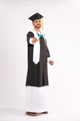 Achieving the dream of success, expressions of happiness and pleasure, university occasion and celebration, celebration of completing university studies, concept of diligence and excellence, portrait of a smiling young Arab Gulf Emirati graduate wearing a graduation gown holding a certificate in his hand, full body, white background