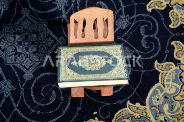 A Saudi Arabian Gulf child sitting in the mosque, praying and supplicating in the mosque, reading the Qur’an, worshiping in the houses of God