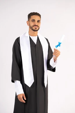 Holding a certificate with expressions of joy and happiness, feeling proud and self-confident, celebrating success and completing university studies, the concept of excellence and diligence, a portrait of an Arab Gulf Emirati graduate wearing a graduation cap and gown, standing straight with gestures of happiness, white background