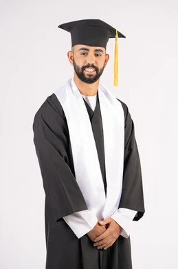 Grandfather, success and diligence, taking selfies in graduation gowns, celebrating the completion of university, portrait of a smiling young Arab Gulf Emirati graduate wearing a graduation cap and gown, standing straight and looking at the camera with expressions of self-confidence, pleasure and happiness, white background