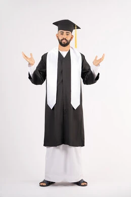 The concept of excellence and success, taking selfies in graduation gowns, celebrating the completion of university, portrait of a smiling young Arab Gulf Emirati graduate wearing a graduation cap and gown, raising his hands up, looking at the camera with an expression of pleasure, full body, white background