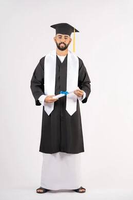Achieving the dream of success, expressions of happiness and pleasure, university occasion and celebration, celebration of completing university studies, concept of diligence and excellence, portrait of a smiling young Arab Gulf Emirati graduate wearing a graduation gown holding a certificate in his hand, full body, white background