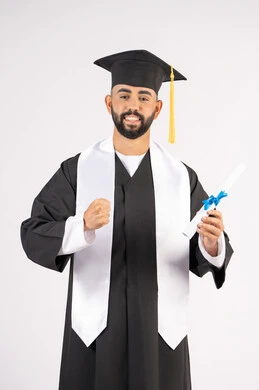 Feeling proud and confident, holding a certificate with expressions of joy and victory, celebrating success and completing university studies, the concept of excellence and diligence, portrait of an Arab Gulf Emirati graduate wearing a graduation cap and gown, standing straight with gestures of happiness, white background
