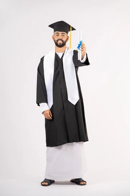 Achieving the dream of success, expressions of happiness and pleasure, university occasion and celebration, celebration of completing university studies, concept of diligence and excellence, portrait of a smiling young Arab Gulf Emirati graduate wearing a graduation gown holding a certificate in his hand, full body, white background