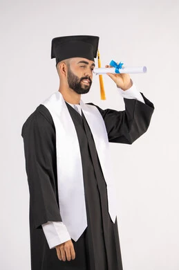 الفخر والفرح بالوصول لحلم التخرج, التطلع إلى المستقبل بعد التخرج، بورتريه من الجانب لشاب خريج عربي سعودي خليجي يرتدي ثياب التخرج ينظر من خلال شهادة التفوق، الاحتفال بانتهاء المرحلة الجامعية، خلفية بيضاء