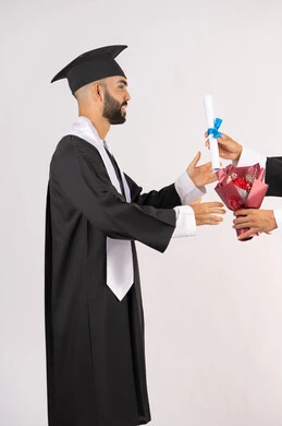 Celebrating success and completing university studies, feeling proud and self-confident, receiving the certificate with expressions of joy and happiness, the concept of excellence and diligence, a side portrait of an Arab Gulf Emirati graduate wearing a graduation cap and gown taking a bouquet of flowers with gestures of happiness, white background