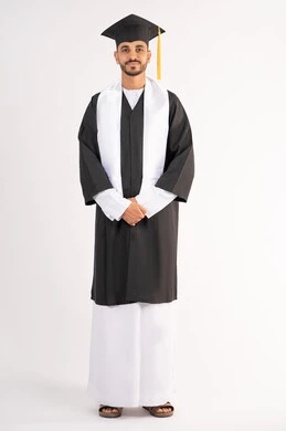 The concept of excellence, success and diligence, celebrating the completion of university, standing up straight and taking selfies in graduation clothes, portrait of a smiling young Arab Gulf Emirati graduate wearing a graduation cap and gown looking at the camera with an expression of pleasure, full body, white background