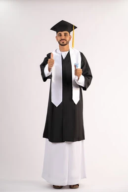 Thumbs up expression, selfie in graduation gown, celebrating graduation, portrait of a young Emirati Gulf Arab graduate wearing a graduation cap and gown holding a diploma looking at the camera with gestures of pleasure, full body, white background