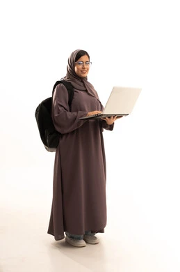 Research and reading and browsing electronic applications, checking grades through the laptop, a portrait of an Arab Gulf Saudi student wearing a hijab and abaya and carrying a school bag using a laptop, preparing for the new university academic year, looking at the camera with gestures of happiness and joy, full-body, white background.