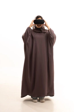 Integration and simulation of the imaginary world, technological and technical development, enjoyment and entertainment through viewing via virtual reality glasses, a portrait of a Saudi Arabian Gulf woman wearing a hijab and abaya looking through 3D glasses (VR), full-body image, white background. Integration and simulation of the imaginary world, technological and technical development, enjoyment and entertainment through viewing via virtual reality glasses, a portrait of a Saudi Arabian Gulf woman wearing a hijab and abaya looking through 3D glasses (VR), full-body image, white background.