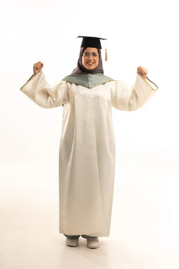 The concept of diligence and excellence, celebrating the completion of university studies, expressions of success and victory, the feeling of pride and self-confidence, a portrait of a Gulf Arab Saudi female student wearing an abaya and graduation cap, raising her hands upwards in gestures of victory, full-body, white background.