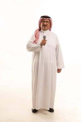 Presenting audio shows, working in television program hosting, aging and dignity, a portrait of an elderly Arab Gulf Saudi man wearing traditional attire and a headscarf standing upright, attention to external appearance, the concept of Arab masculinity, full-body, white background.