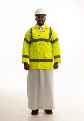A portrait of a smiling Saudi Arabian Gulf engineer wearing traditional attire, a helmet, and a safety vest, looking with gestures of joy. Professions and jobs in Saudi Arabia, working in the engineering sector, the concept of engineering and architectural constructions, building with the hands of the nation's sons.