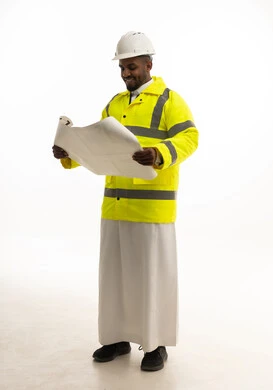 Reconstruction with the hands of the nation's sons, direct monitoring and supervision of work, the concept of engineering and architectural construction, a portrait of a Saudi Gulf Arab engineer wearing traditional attire and a special jacket and safety helmet, standing with an engineering plan in hand, full-body, white background.