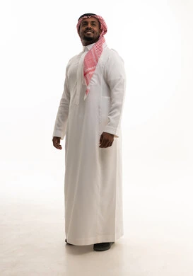 The focus on elegance and appearance, the concept of masculinity, strength, and self-confidence, a portrait of a Saudi Arabian Gulf man wearing a ghutrah and traditional attire looking at the camera with gestures of joy and happiness, white background.