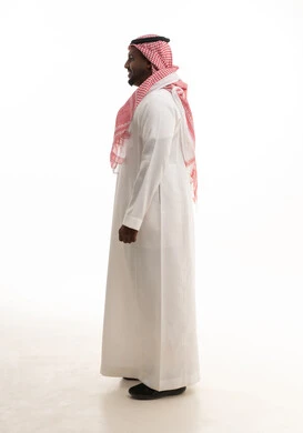 The concept of masculinity, strength, and self-confidence, a portrait of a Saudi Gulf Arab man wearing a ghutrah and traditional attire looking at the camera with gestures of joy and happiness, attention to elegance and appearance, white background.