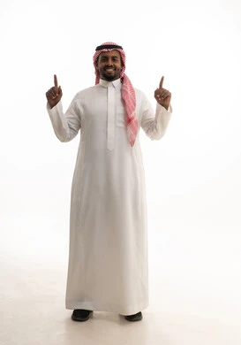 Identifying the location of a specific element, a portrait of a smiling Saudi Arabian Gulf man wearing a ghutrah and traditional thobe pointing with his index finger to something, full body, indicating a specific location, gestures indicating this place (here), white background.