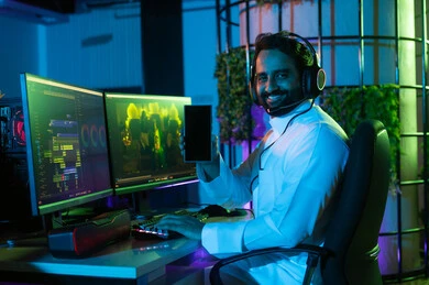 Looking at the camera with expressions of happiness, the concept of digital content creation, using a mobile phone, a side image of an Arab Gulf Saudi editor wearing a white thobe and headphones sitting inside the studio working on arranging scenes using advanced computer and mobile programs, gestures of thinking and focus.