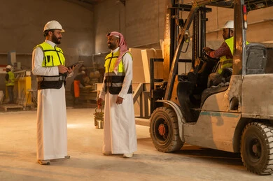 Workshops in Saudi Arabia, tools and equipment made of marble, quality local production, home and office furniture manufacturing, two Saudi Arabian Gulf engineers wearing traditional thobes and work clothes working on tablets, integrating technology in laboratories