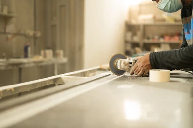 Traditional Saudi Arabian crafts and professions, workshop and factory, use of carpentry tools and equipment, close-up of a Saudi Arabian Gulf craftsman filing and leveling a piece of wood in a carpentry shop