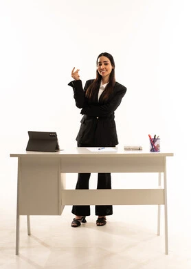 Integrating education with technology: A portrait of a Saudi Arabian teacher wearing a black formal suit, standing in front of a white desk and pointing at something, explaining using a tablet. Full-length portrait, white background.