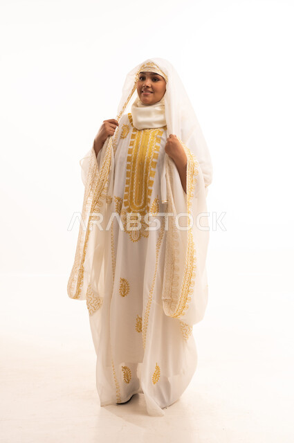 Anniversary of the founding of the first Saudi state, February 22, interest in outward appearance and softness, portrait of a smiling Saudi Arabian Gulf woman wearing a sheyla and a neshel, looking at the camera with expressions of pride and honor, the day of our beginnings 1727 AD, wearing the costumes of the Eastern Province, full body length, white background