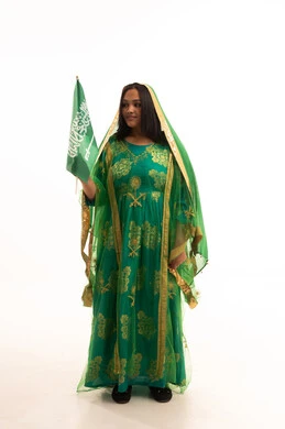 Flag Day, March 11, standing upright with proud gestures, wearing the traditional costume of the central region on a national occasion, Badina Day, February 22, Saudi National Day, September 23, portrait of a Saudi Arabian Gulf woman wearing a sheila and bisht holding the flag of the Kingdom, full body length, white background