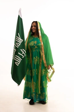 الاحتفال بيوم بدينا ١٧٢٧م، الوقوف باستقامة ورفع علم التأسيس بتعابير الشموخ والتباهي، ايماءات البهجة والسرور، ذكرى تأسيس الدولة السعودية الاولى ٢٢ فبراير، بورتريه لامرأة عربية خليجية سعودية ترتدي الشيلة والبشت، صورة لكامل الجسم، خلفية بيضاء الاحتفال بيوم بدينا ١٧٢٧م، الوقوف باستقامة ورفع علم التأسيس بتعابير الشموخ والتباهي، ايماءات البهجة والسرور، ذكرى تأسيس الدولة السعودية الاولى ٢٢ فبراير، بورتريه لامرأة عربية خليجية سعودية ترتدي الشيلة والبشت، صورة لكامل الجسم، خلفية بيضاء