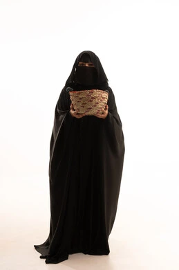 Women's handicrafts, traditional folk crafts and works, celebrating Badina Day 1727 AD, the anniversary of the founding of the first Saudi state, February 22, portrait of a Saudi Arabian Gulf woman wearing a burqa and black abaya carrying a basket made of straw, full body image, white background Women's handicrafts, traditional folk crafts and works, celebrating Badina Day 1727 AD, the anniversary of the founding of the first Saudi state, February 22, portrait of a Saudi Arabian Gulf woman wearing a burqa and black abaya carrying a basket made of straw, full body image, white background