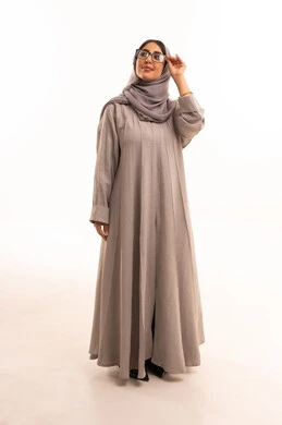 Correction and improvement of vision, the joy of shopping in Saudi Arabia, acquiring new prescription glasses, the concept of poor eyesight, a portrait of an Arab Gulf Saudi woman wearing a hijab and abaya choosing suitable glasses for her facial features, full-body, white background.