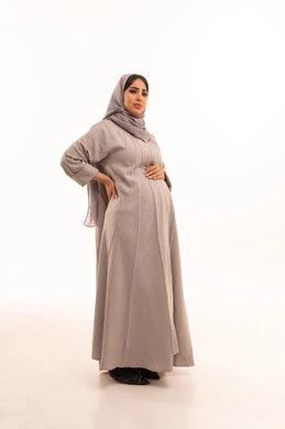 Back and spine pain, feeling unwell and fatigued, the need for treatment and medical consultation, a portrait of a pregnant Saudi Arabian Gulf woman wearing an abaya and hijab, placing her hand on her back with gestures of fatigue, full-body image, white background. Back and spine pain, feeling unwell and fatigued, the need for treatment and medical consultation, a portrait of a pregnant Saudi Arabian Gulf woman wearing an abaya and hijab, placing her hand on her back with gestures of fatigue, full-body image, white background.