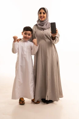 A blank black screen displayed on a mobile phone, a portrait of a pregnant Arab Gulf Saudi woman wearing an abaya and hijab holding a mobile phone with her son, expressions of joy and achievement, full body, white background.