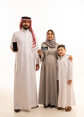 A black screen displayed on a mobile phone, using sonar technology to examine the fetus inside the womb, a portrait of a pregnant Arab Gulf Saudi woman wearing an abaya and hijab holding a sonar image in her hands accompanied by her husband and son, the concept of pregnancy and childbirth, gestures of happiness and joy, full-body image, white background.
