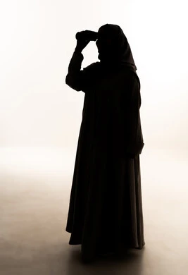 Love of exploration and adventure, seeing distant things through a telescope, a silhouette of an Arab Gulf Saudi woman wearing an abaya and hijab holding binoculars in her hands, full-body image, white background, silhouette.