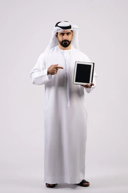Portrait of an Emirati Gulf Arab man wearing a kandura and ghutra using a tablet, gestures of interaction and integration, integration of modern technologies in practical life, displaying a blank black screen, full body image, white background