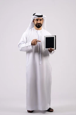 Gestures of interaction and integration, integration of modern technologies in practical life, display of a blank black screen, portrait of an Emirati Gulf Arab man wearing a kandura and ghutra using a tablet, full body image, white background
