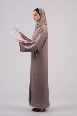 أوراق خاصة بالعمل, تدوين المهام اليومية ،شابه سعوديه تقوم بالبحث العلمي، قراءة الملاحظات والمعلومات ، متابعة الخطط والمشاريع ،بورتريه لامراة عربيه خليجيه اماراتيه محجبه ترتدي العباءة السوداء تحمل بيديها ورقة بيضاء ،  خلفية بيضاء