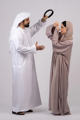 Woman defending herself, quarrel between spouses, family problems and domestic conflict, crisis in family relations, portrait of an Arab Gulf Emirati couple arguing with each other, white background