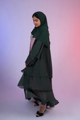 Modern elegant hijab clothing, portrait of an Emirati Gulf Arab woman wearing hijab and abaya standing straight with a confident expression, a Saudi woman looking with gestures of cheerfulness and admiration, full body, colored background