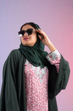 Women's fashion and accessories, gestures of femininity and beauty, Emirati woman wearing an elegant abaya and contemporary black glasses, portrait of a veiled Saudi Arabian Gulf woman trying out new sunglasses, interest in outward appearance and elegance, colorful background