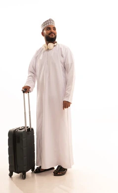 A recreational tour during the summer vacation, looking at something, a portrait of a young Arab Gulf Omani man wearing a dishdasha and kumma holding a travel bag in his hand, preparing for an enjoyable summer trip, full-body image, white background.