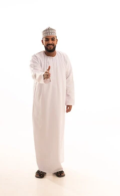 Getting to know each other, friendship, and building relationships, greeting and peace, a portrait of an Omani Arab man wearing a dishdasha and kumma extending his hand for a handshake, the concept of reception and welcome, full-body, white background.