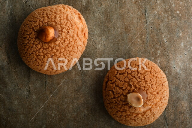 Sweetened dough, donuts, benz, coffee sweets, pieces of sweets cut on a table.