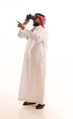 The concept of exploration and adventure, searching for something and expanding the field of vision using binoculars, futuristic visions among youth, a portrait of an Arab Gulf Saudi man wearing a ghutrah and traditional thobe looking through binoculars, full body length, white background.