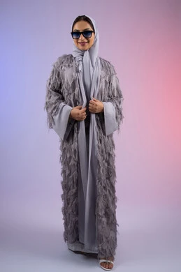 Marketing of modern women's fashion and accessories, the concept of elegance and beauty, interest in outward appearance, a smiling Emirati woman wearing an abaya looking at the camera with an expression of femininity and pleasure, a portrait of a veiled Saudi Arabian Gulf woman wearing sunglasses, full body, colored background